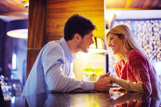 romantic evening date in restaurant  happy young couple with wine glass tea and cake