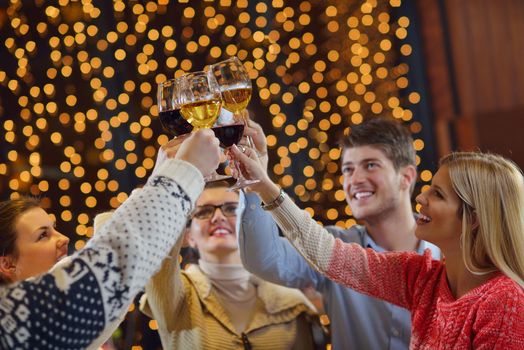 Group of happy young people drink wine at party disco restaurant