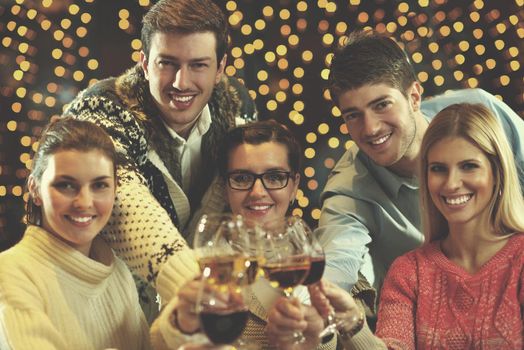 Group of happy young people drink wine at party disco restaurant