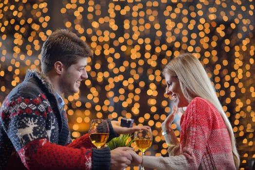 The young man gives a wedding ring   gift to  girl in restaurant