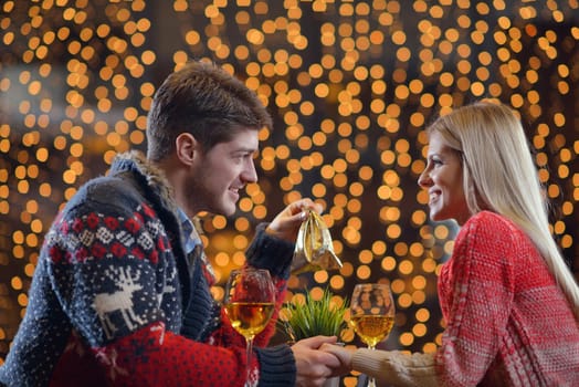 The young man gives a wedding ring   gift to  girl in restaurant