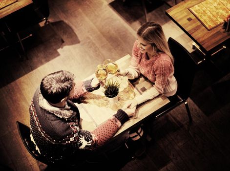 romantic evening date in restaurant  happy young couple with wine glass tea and cake