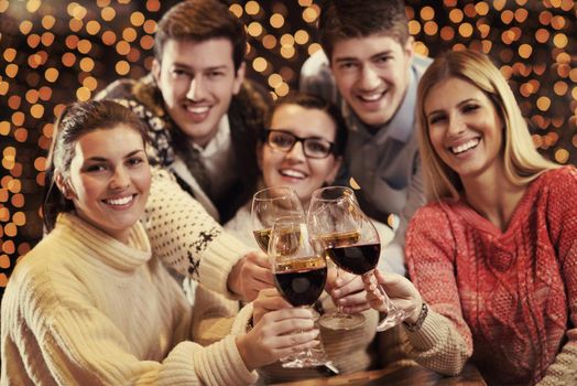 Group of happy young people drink wine at party disco restaurant