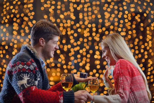 The young man gives a wedding ring   gift to  girl in restaurant