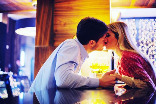 romantic evening date in restaurant  happy young couple with wine glass tea and cake