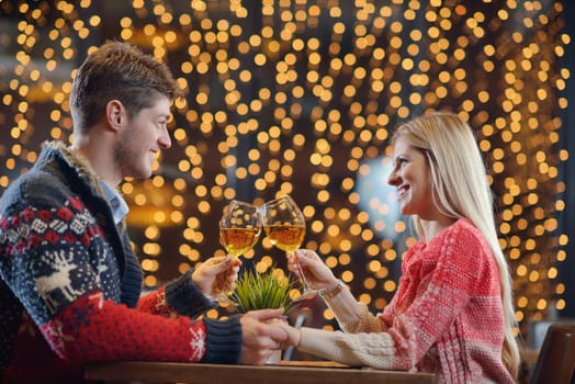 romantic evening date in restaurant  happy young couple with wine glass tea and cake