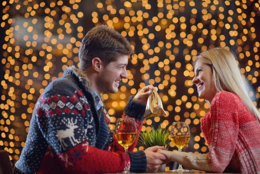 The young man gives a wedding ring   gift to  girl in restaurant