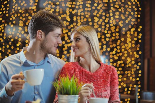 romantic evening date in restaurant  happy young couple with wine glass tea and cake