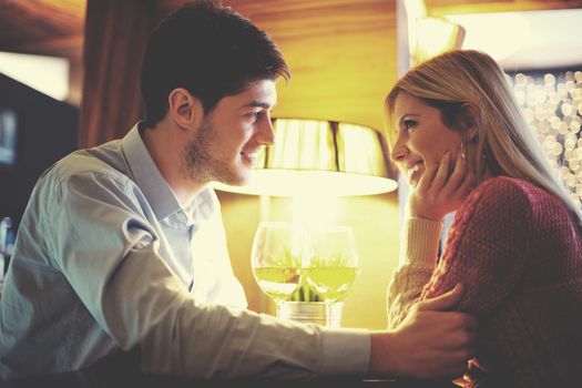 romantic evening date in restaurant  happy young couple with wine glass tea and cake