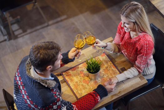 romantic evening date in restaurant  happy young couple with wine glass tea and cake