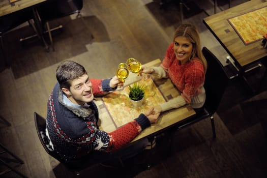 romantic evening date in restaurant  happy young couple with wine glass tea and cake