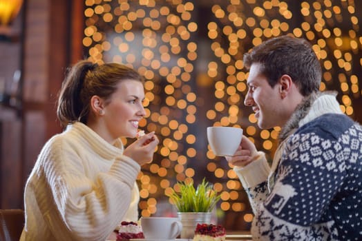 romantic evening date in restaurant  happy young couple with wine glass tea and cake