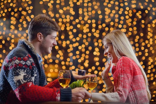 The young man gives a wedding ring   gift to  girl in restaurant