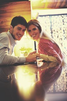 romantic evening date in restaurant  happy young couple with wine glass tea and cake