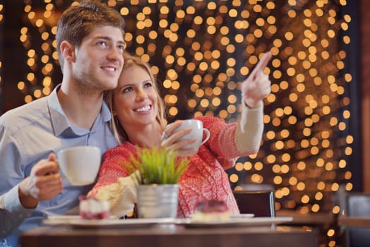 romantic evening date in restaurant  happy young couple with wine glass tea and cake