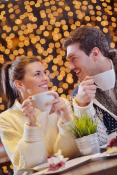 romantic evening date in restaurant  happy young couple with wine glass tea and cake