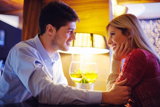 romantic evening date in restaurant  happy young couple with wine glass tea and cake