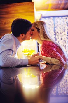 romantic evening date in restaurant  happy young couple with wine glass tea and cake