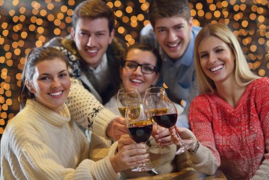 Group of happy young people drink wine at party disco restaurant