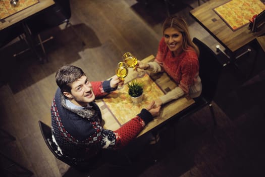 romantic evening date in restaurant  happy young couple with wine glass tea and cake