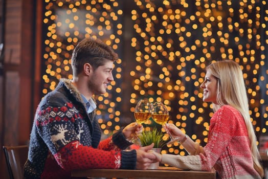 romantic evening date in restaurant  happy young couple with wine glass tea and cake