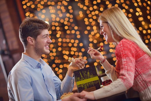 romantic evening date in restaurant  happy young couple with wine glass tea and cake