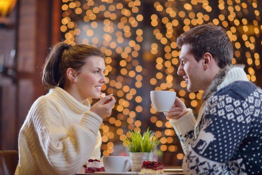 romantic evening date in restaurant  happy young couple with wine glass tea and cake