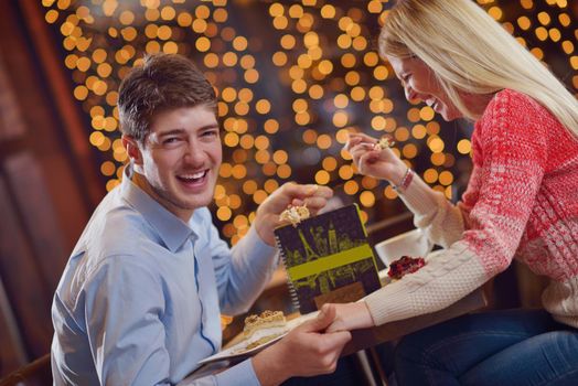 romantic evening date in restaurant  happy young couple with wine glass tea and cake