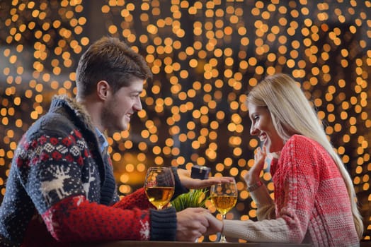 The young man gives a wedding ring   gift to  girl in restaurant