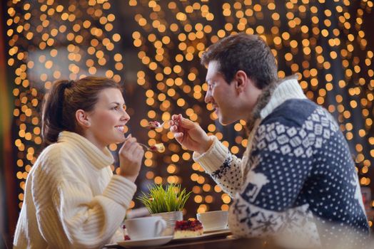 romantic evening date in restaurant  happy young couple with wine glass tea and cake