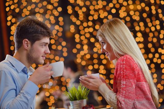 romantic evening date in restaurant  happy young couple with wine glass tea and cake