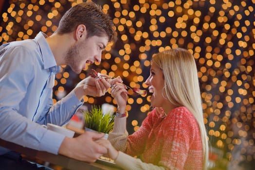 romantic evening date in restaurant  happy young couple with wine glass tea and cake