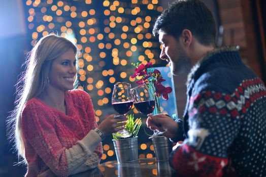 romantic evening date in restaurant  happy young couple with wine glass tea and cake