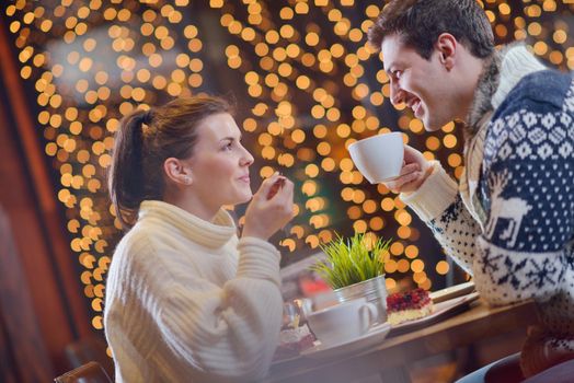 romantic evening date in restaurant  happy young couple with wine glass tea and cake