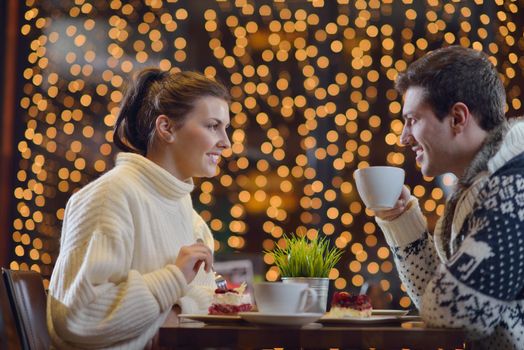 romantic evening date in restaurant  happy young couple with wine glass tea and cake