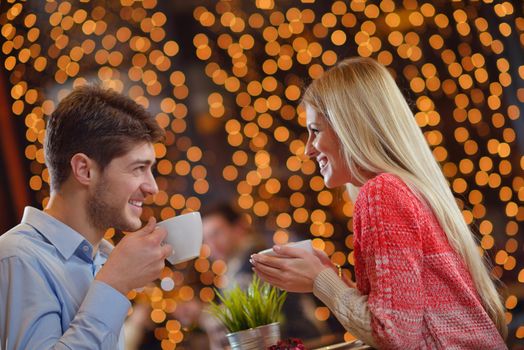 romantic evening date in restaurant  happy young couple with wine glass tea and cake