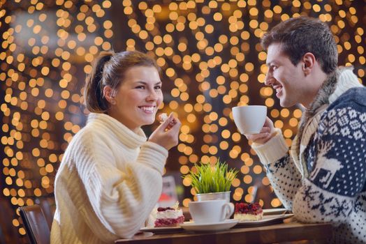 romantic evening date in restaurant  happy young couple with wine glass tea and cake