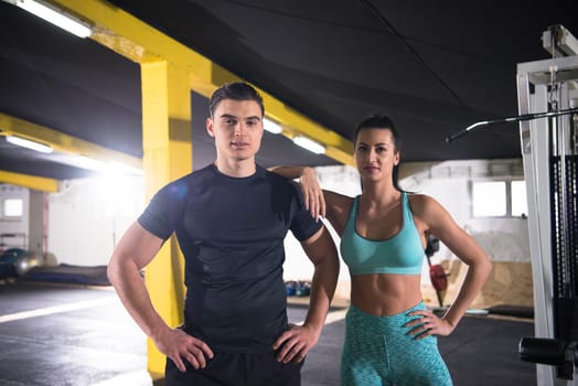 portrait of young healthy athletic people training at cross fitness gym