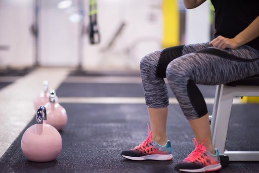 young  woman athlete exercise with fitness kettlebell at cross fitness gym