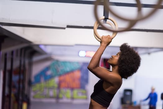 Fitness dip ring beautiful young african american woman workout at gym dipping exercise