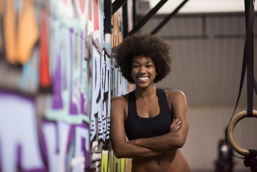 Fitness dip ring african american young woman relaxed after workout at gym dipping exercise