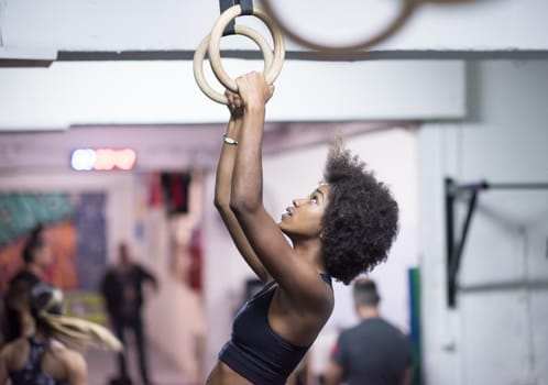 Fitness dip ring beautiful young african american woman workout at gym dipping exercise