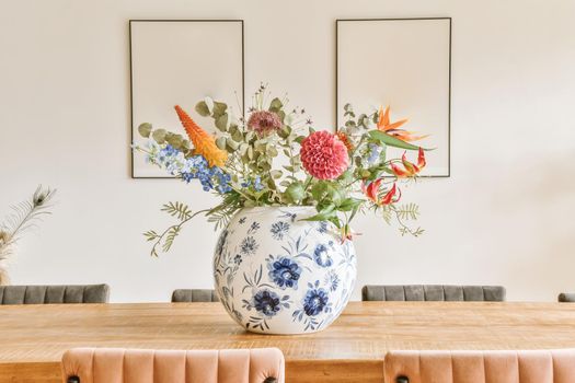 Decor in the form of a vase of flowers above the dining table