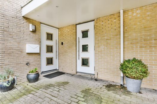 Residential building front door with white door
