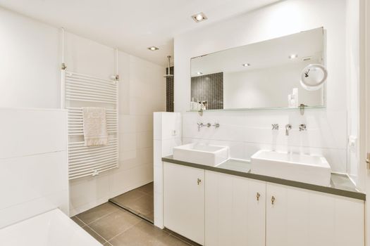Elegant bathroom with two washbasins and a large mirror