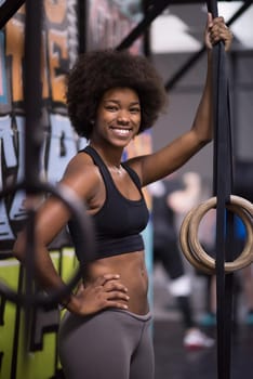 Fitness dip ring african american young woman relaxed after workout at gym dipping exercise