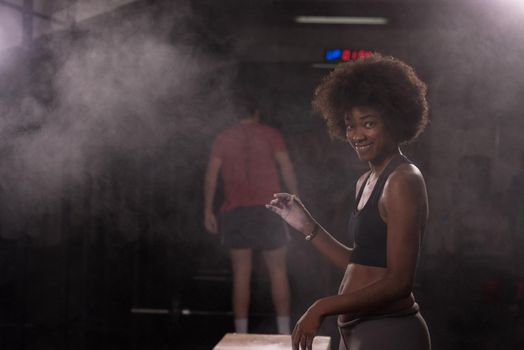 Gym Chalk Magnesium Carbonate hands clapping young african american woman for climbing workout