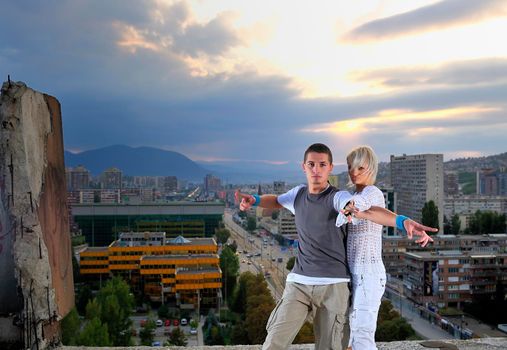 romantic urban couple dancing on top of the bulding