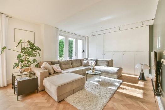 Living room with a large brown sofa and a small round coffee table