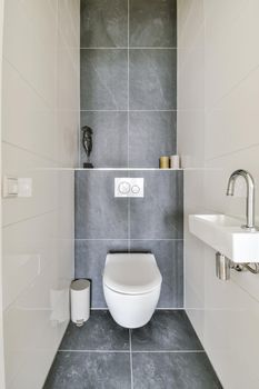 Luxurious restroom with candle shelf and hanging toilet